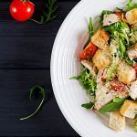 healthy grilled chicken caesar salad with tomatoes cheese and croutons north american cuisine banner top view