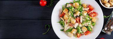 healthy grilled chicken caesar salad with tomatoes cheese and croutons north american cuisine banner top view